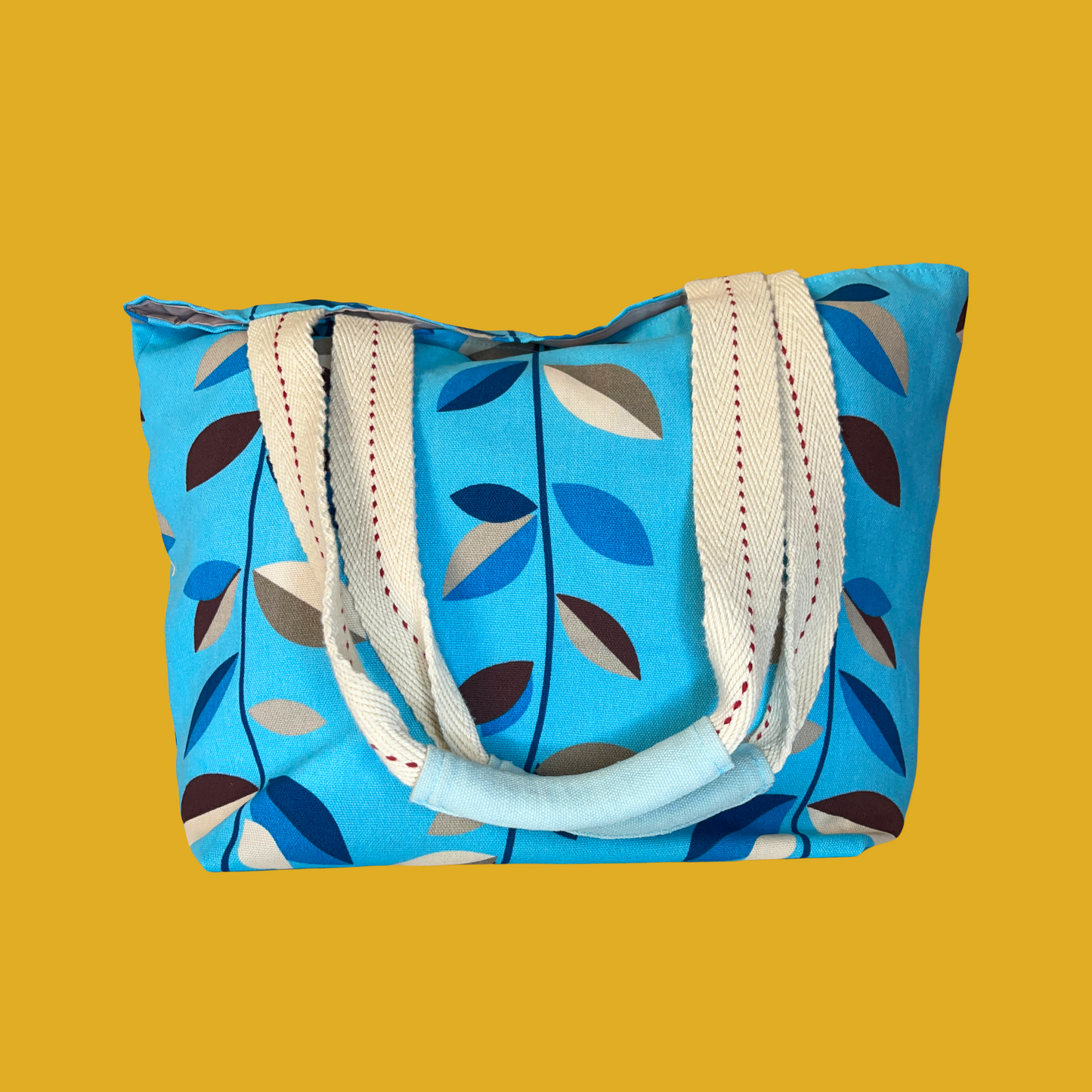 Handbag - Turquoise tote bag with beige, brown and blue leaves and an inside pocket